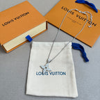 Silver layered charm necklaces with star pendant on white drawstring pouch