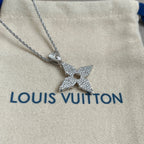 Glitter star charm pendant on silver chain over white drawstring pouch