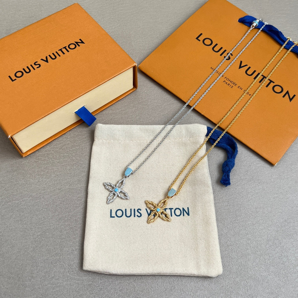 Gold chain necklace set with butterfly charms and blue stones, shown with pouch and boxes