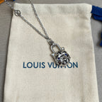 Silver-tone cat pendant charm necklace on cream pouch