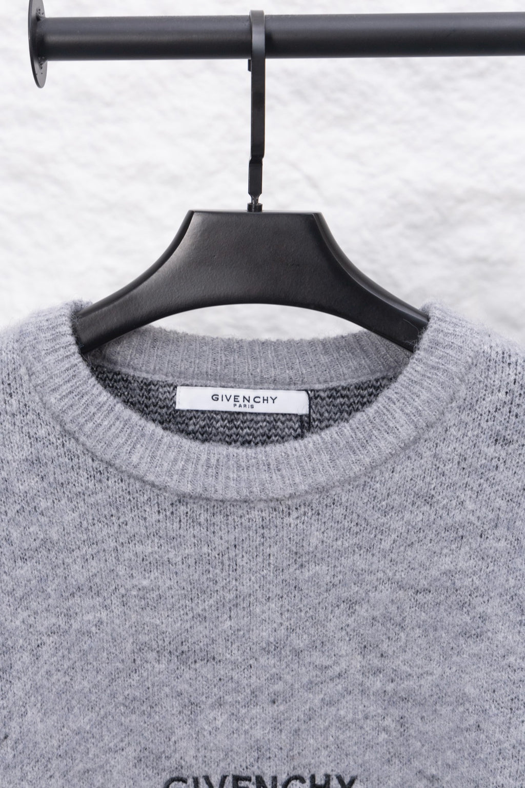 Gray knit sweater neckline with GIVENCHY label on collar