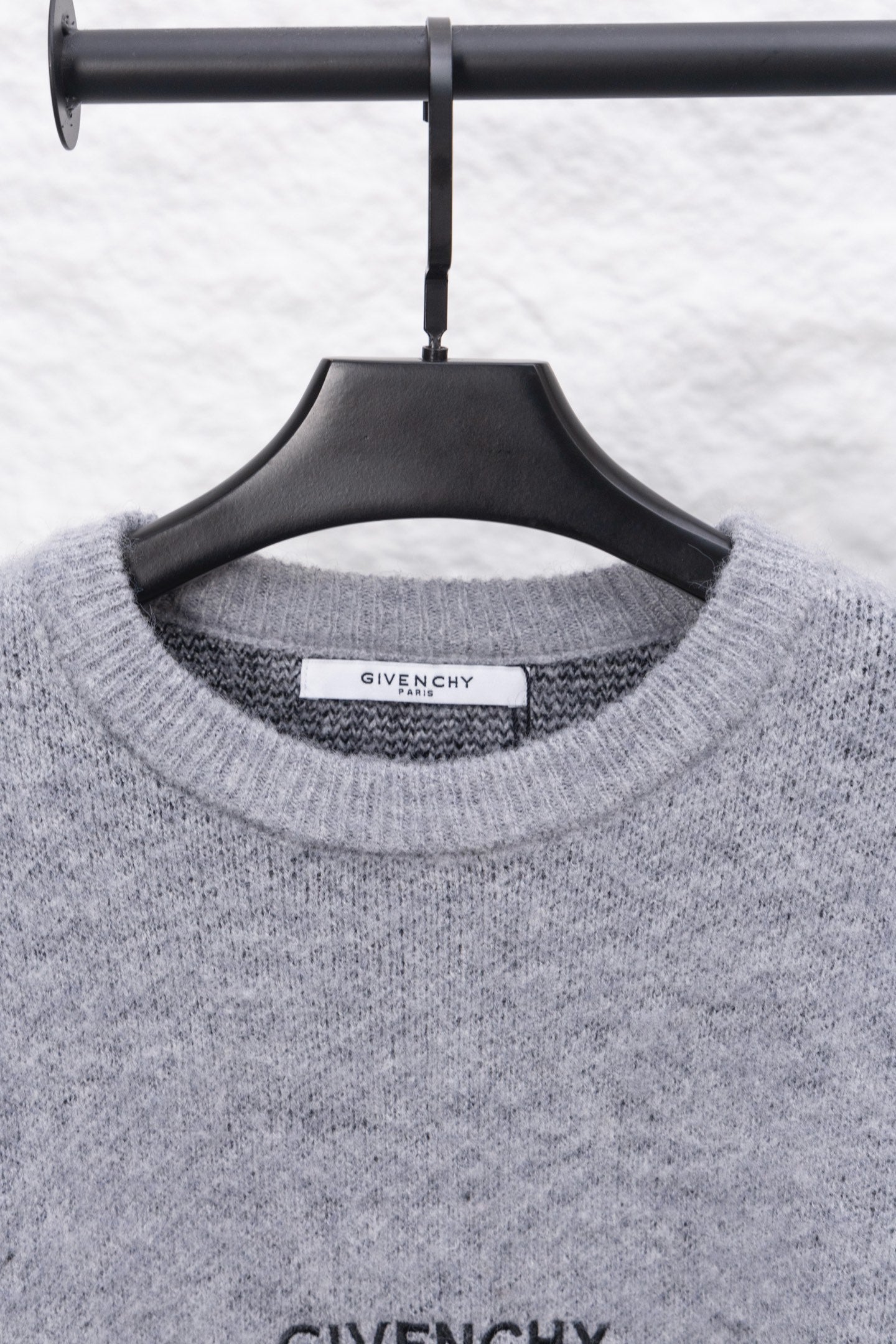 Gray knit sweater neckline with GIVENCHY label on collar