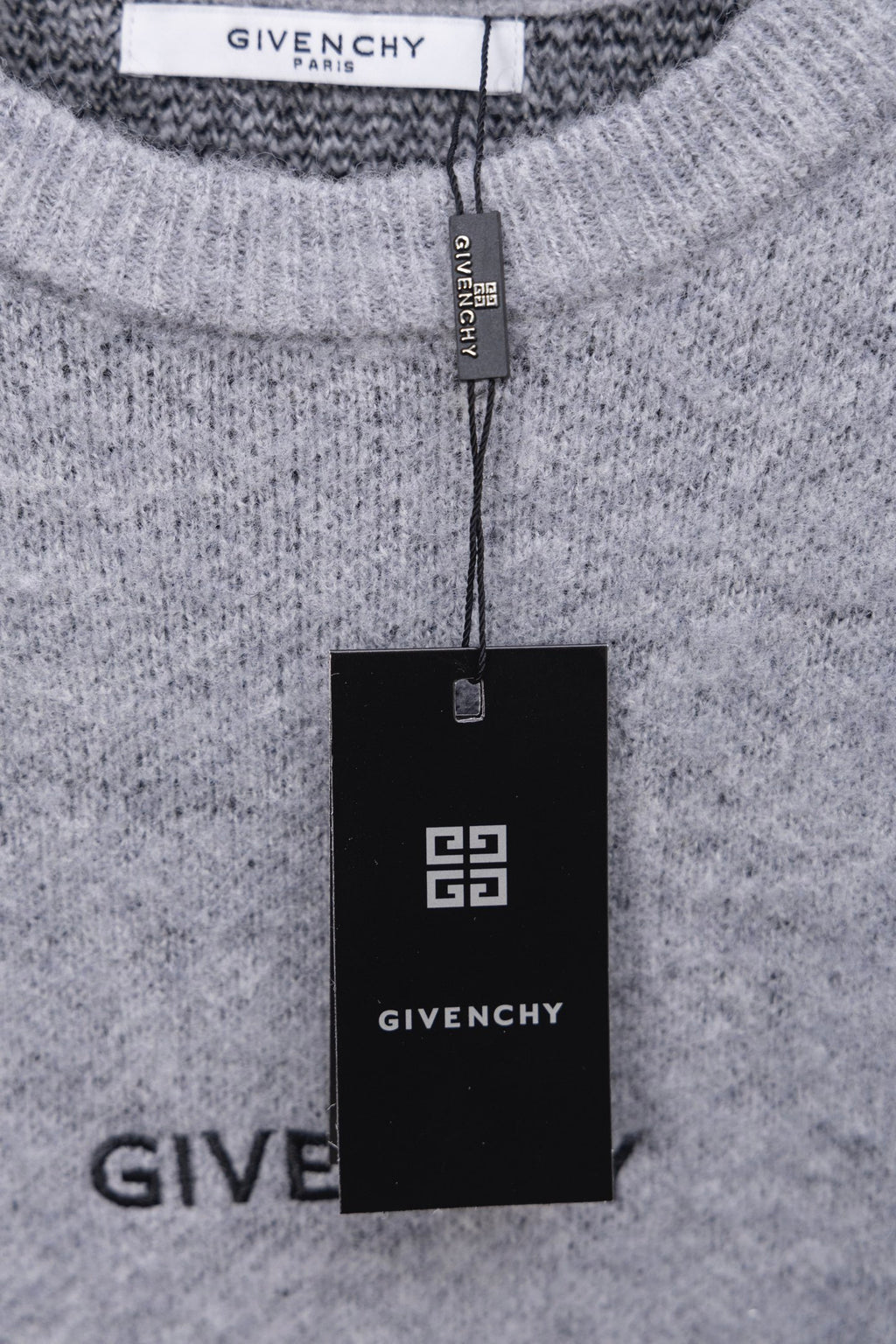Gray knit sweater with GIVENCHY neck label and hanging brand tag