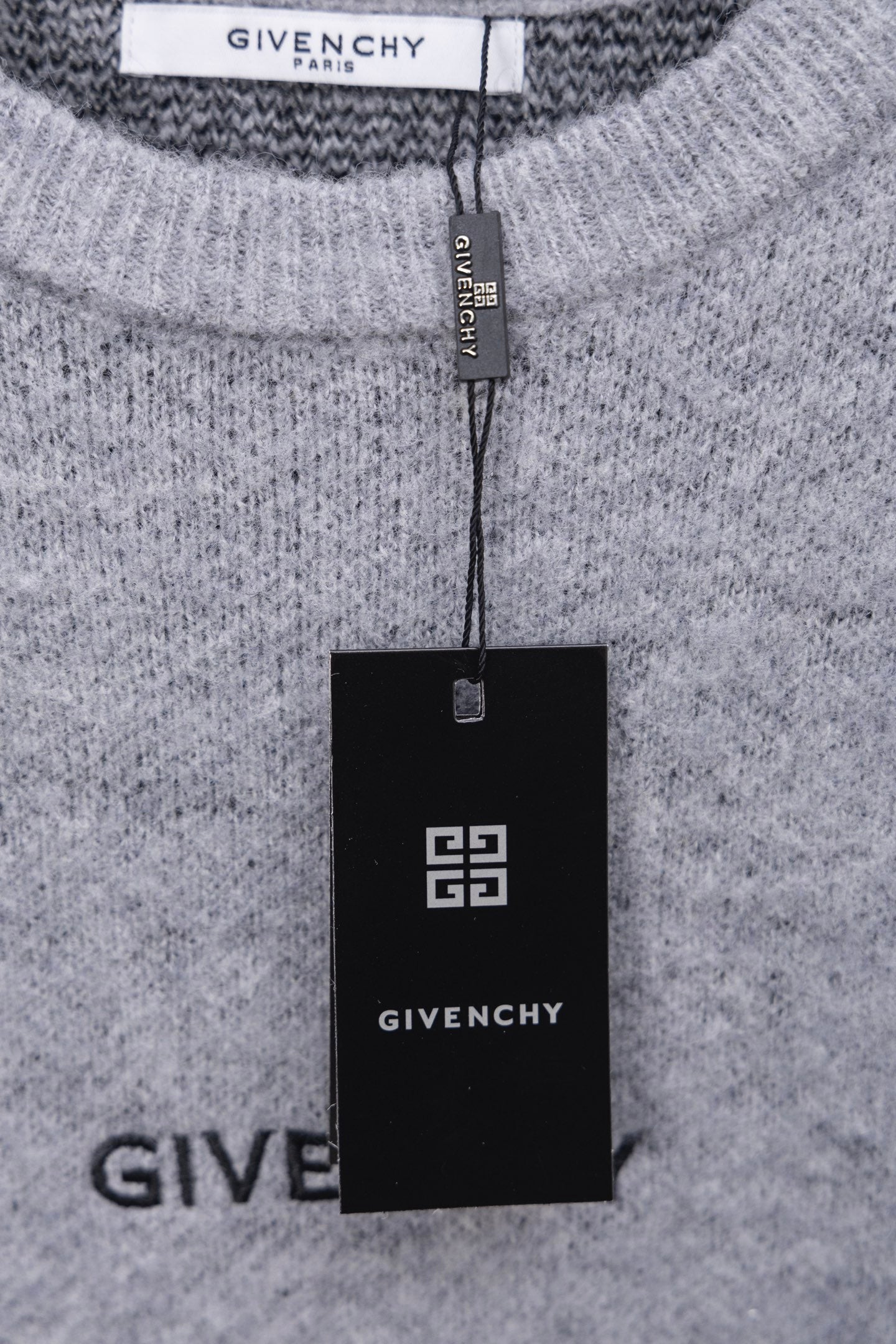 Gray knit sweater with GIVENCHY neck label and hanging brand tag