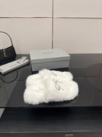 White faux fur slide sandals with silver logo charm detail