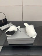 White faux-fur slide sandals, side profile with low heel