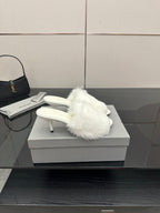 White faux-fur slide sandals with sculpted low heel, side view
