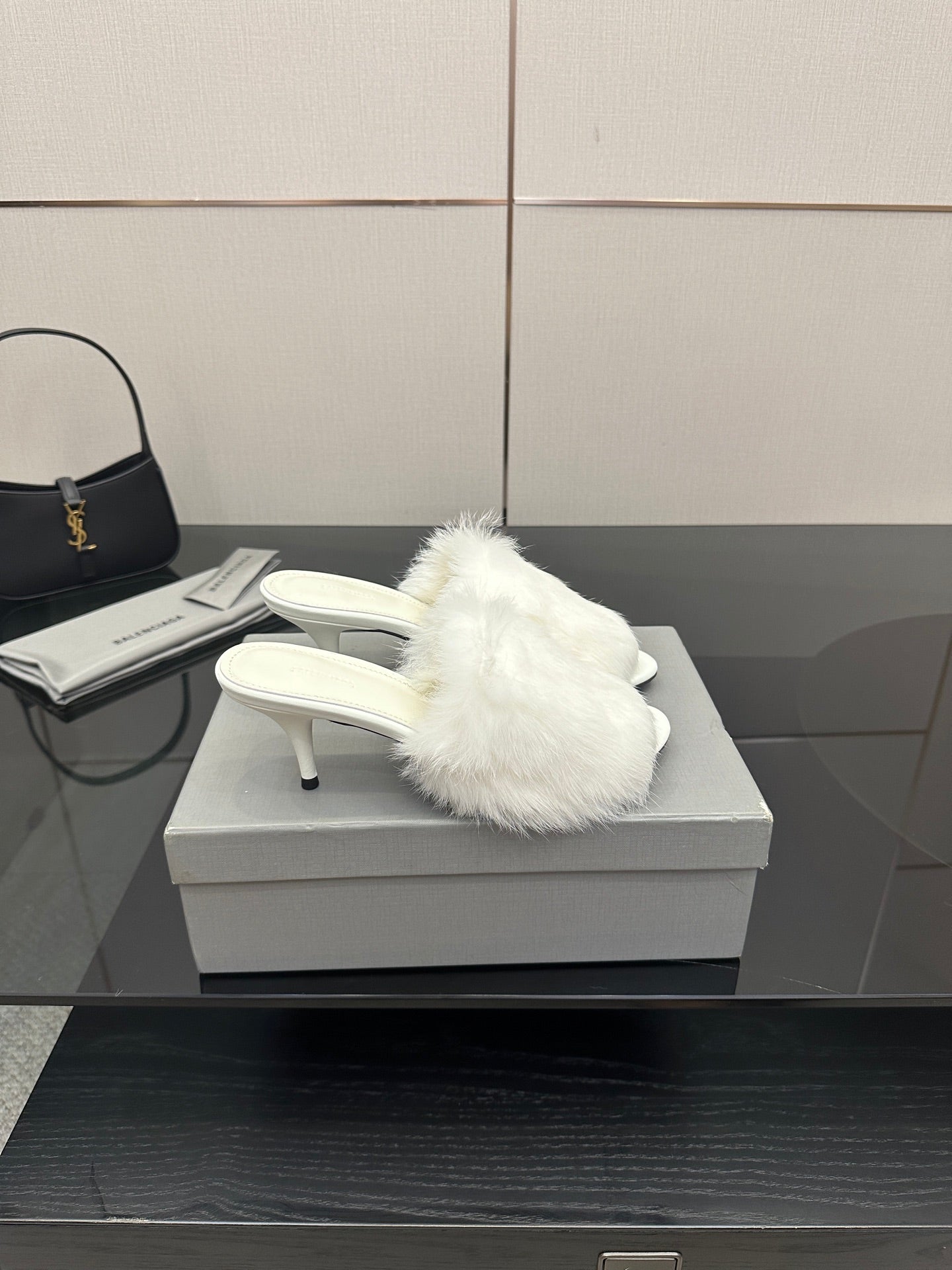 White faux-fur slide sandals with sculpted low heel, side view