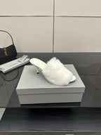 White faux-fur slide sandal with low heel, angled side view