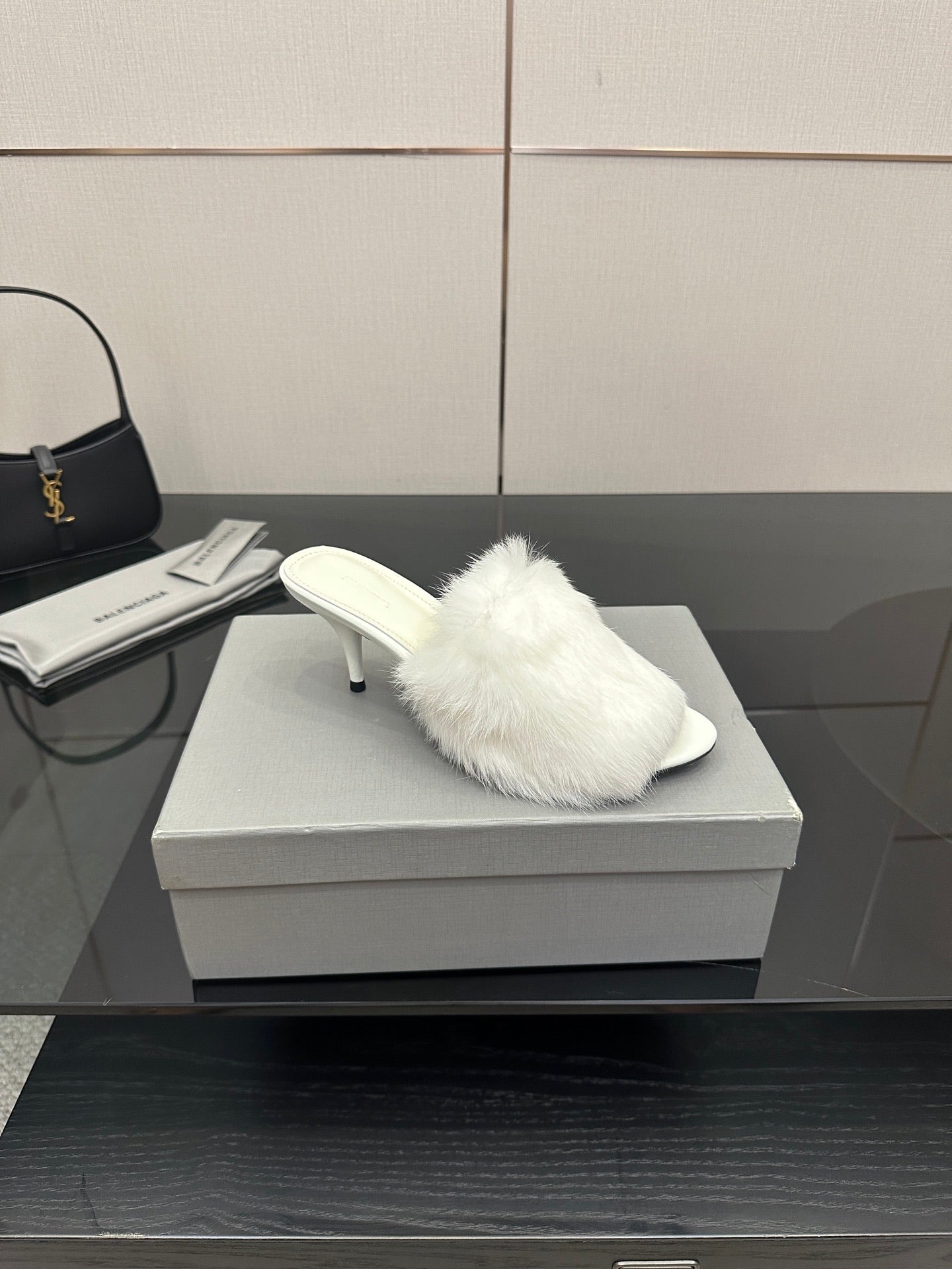 White faux-fur slide sandal with low heel, angled side view