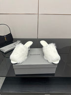 White faux-fur slide sandals, front view with low heel