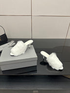 White faux-fur slide sandals, pair on display with low heel