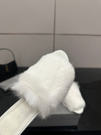 White faux-fur slide sandal close-up, open toe and curved upper