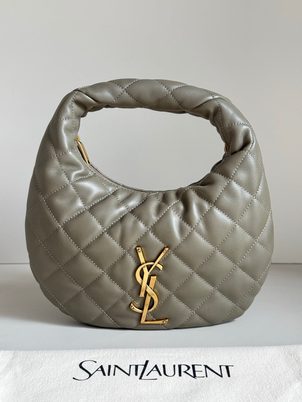 Quilted hobo bag in metallic gray with gold YSL logo and top loop handle