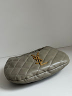 Quilted hobo bag in metallic gray with gold YSL logo, side profile