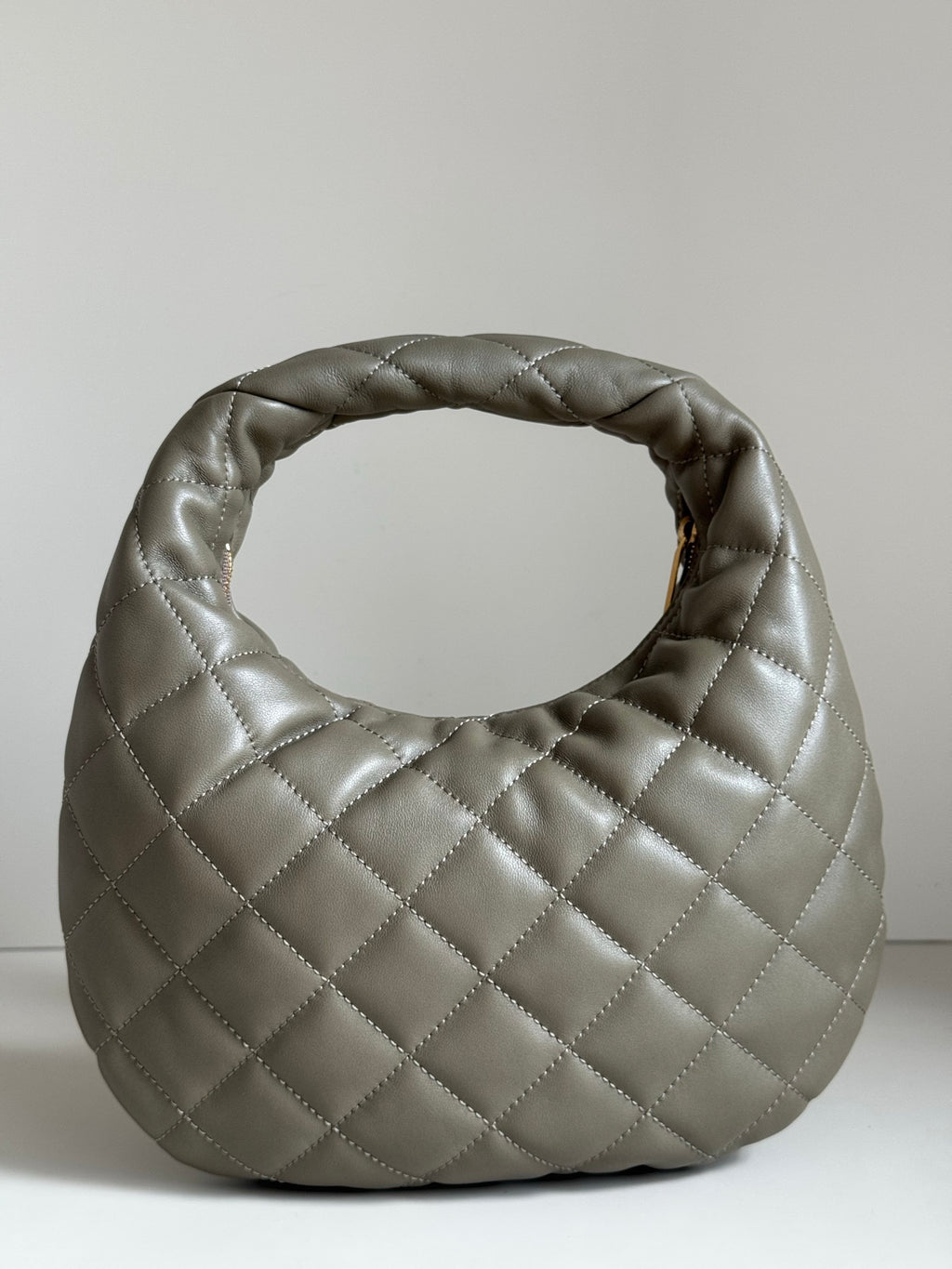 Quilted hobo bag in metallic gray with gold YSL logo on front face