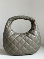 Quilted hobo bag in metallic gray with gold YSL logo on front face