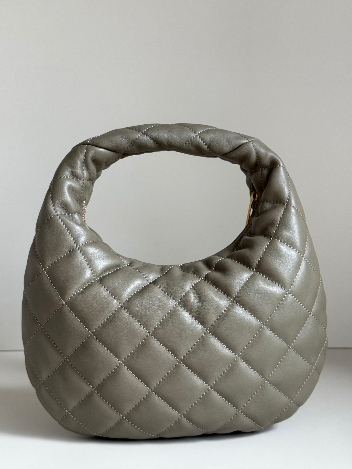 Quilted hobo bag in metallic gray with gold YSL logo on front face