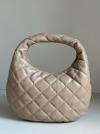 YSL quilted hobo bag in light beige with diamond stitching and rounded silhouette