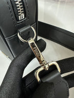 Fendi bag strap attachment detail with silver ring hardware and Fendi logo tag