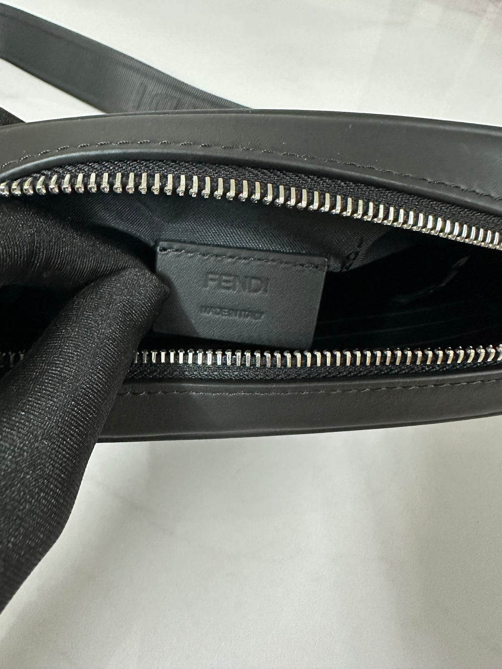 Fendi bag interior view with dual zippers and Fendi logo stamp panel