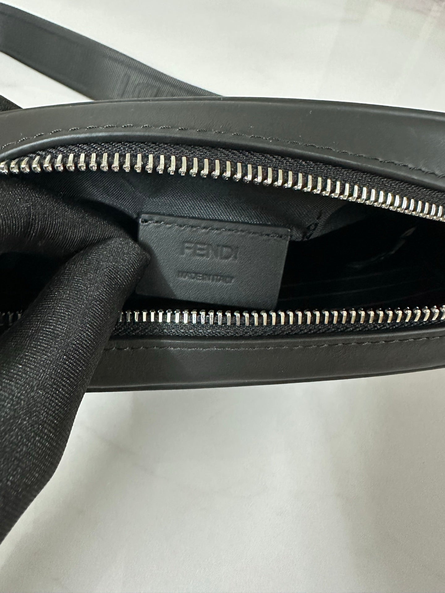 Fendi bag interior view with dual zippers and Fendi logo stamp panel