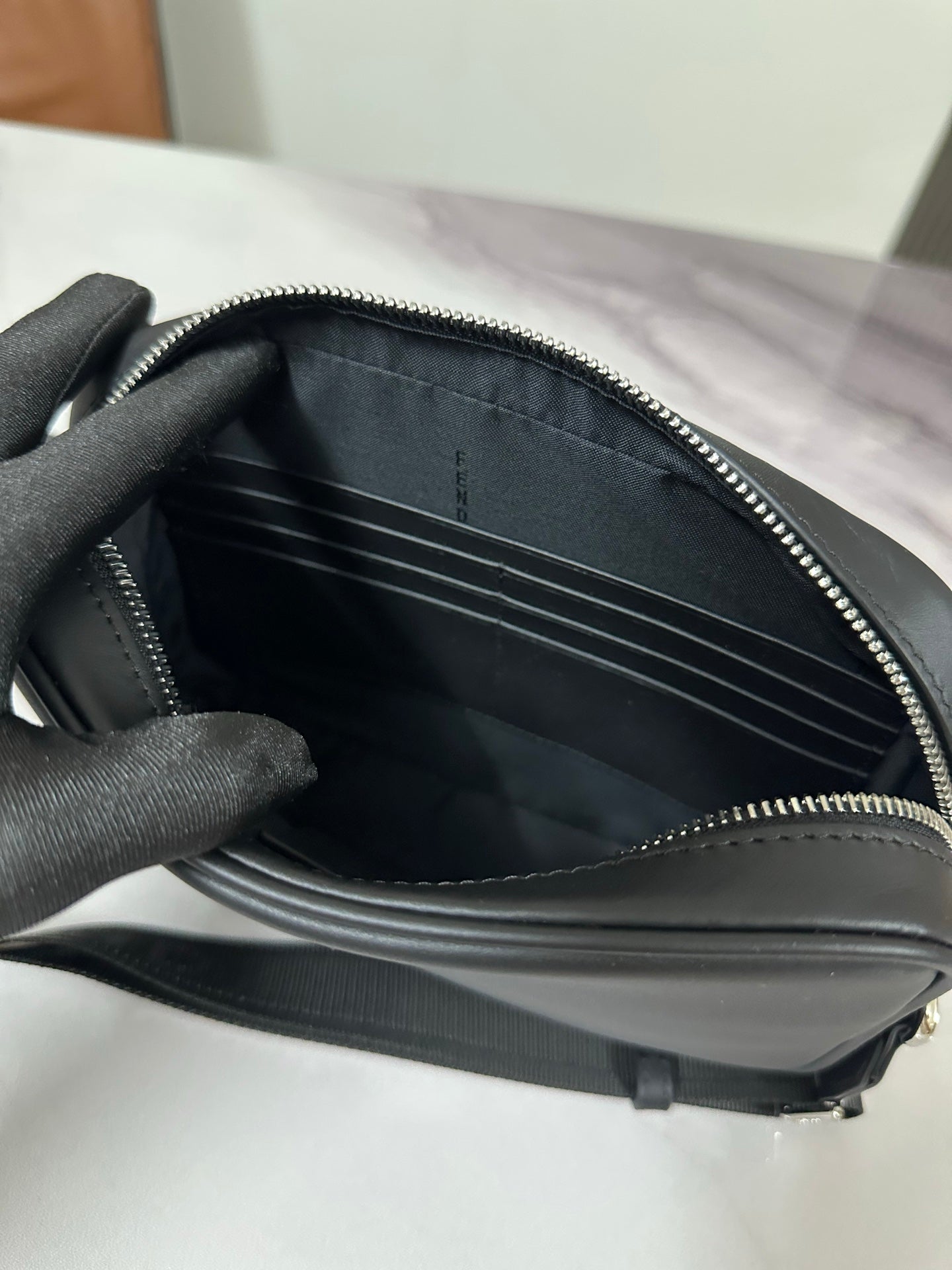 Fendi small bag interior with multiple card slots and black lining, zippered opening