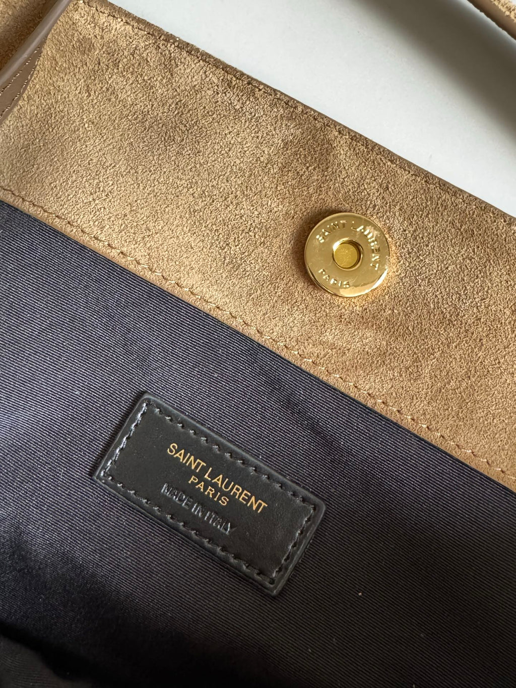 Black interior pocket label and gold snap on tan lining