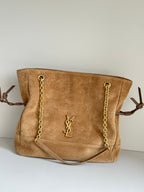 Tan suede tote bag with gold chain straps and YSL logo on front panel