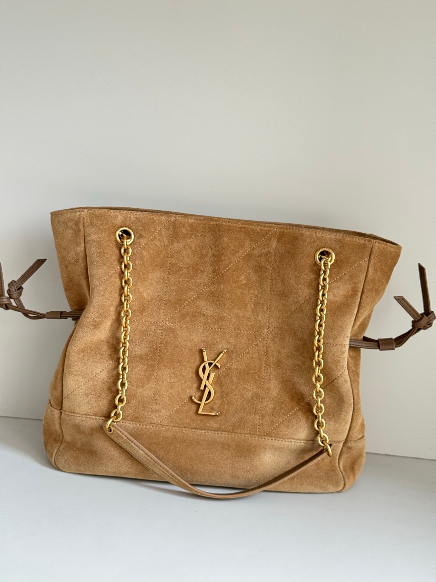 Tan suede tote bag with gold chain straps and YSL logo on front panel