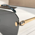 Bvlgari sunglasses detail: black frame corner with gold logo temple