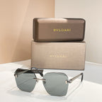 Bvlgari oversized sunglasses with dark green gradient lenses and black frame, gold accents