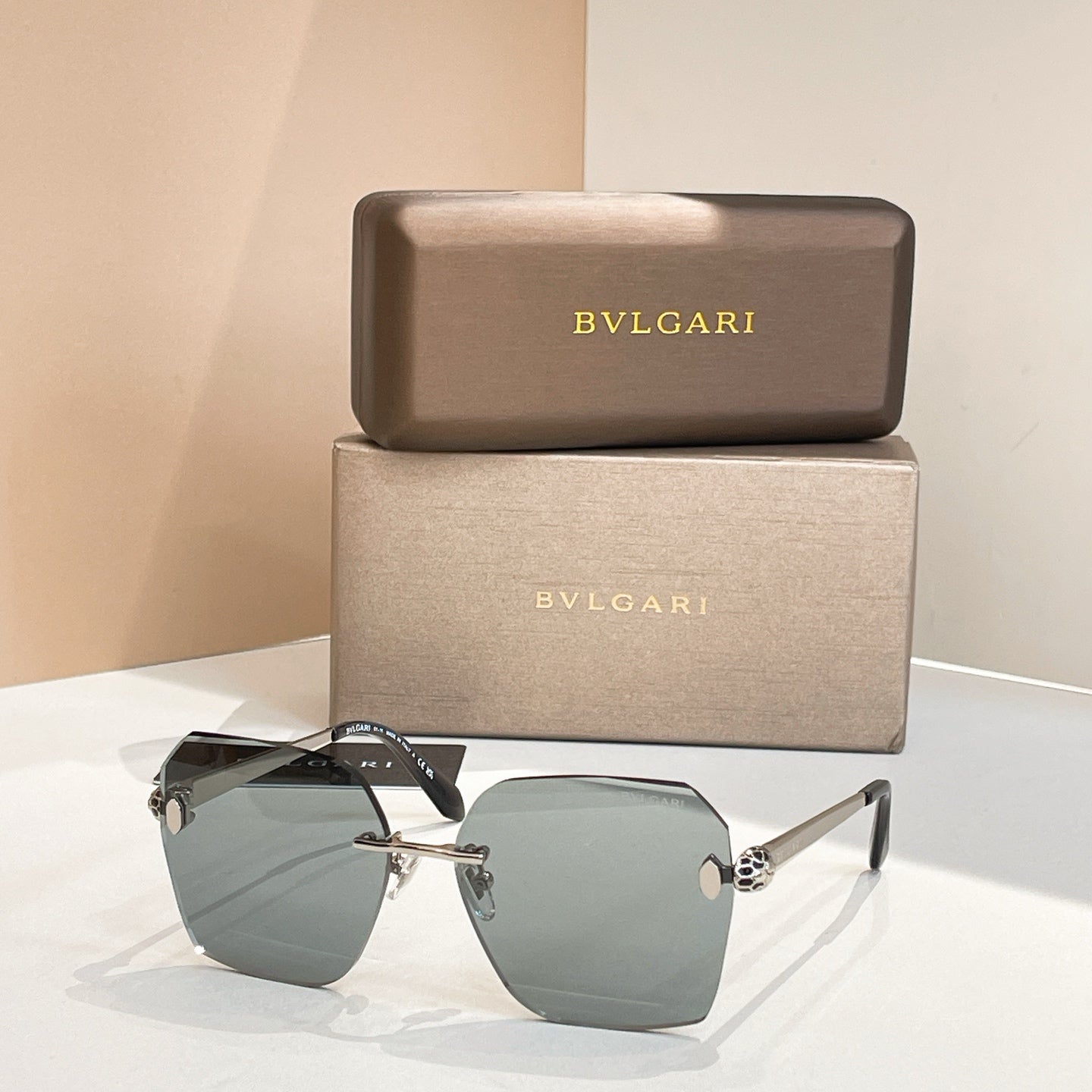 Bvlgari oversized sunglasses with dark green gradient lenses and black frame, gold accents