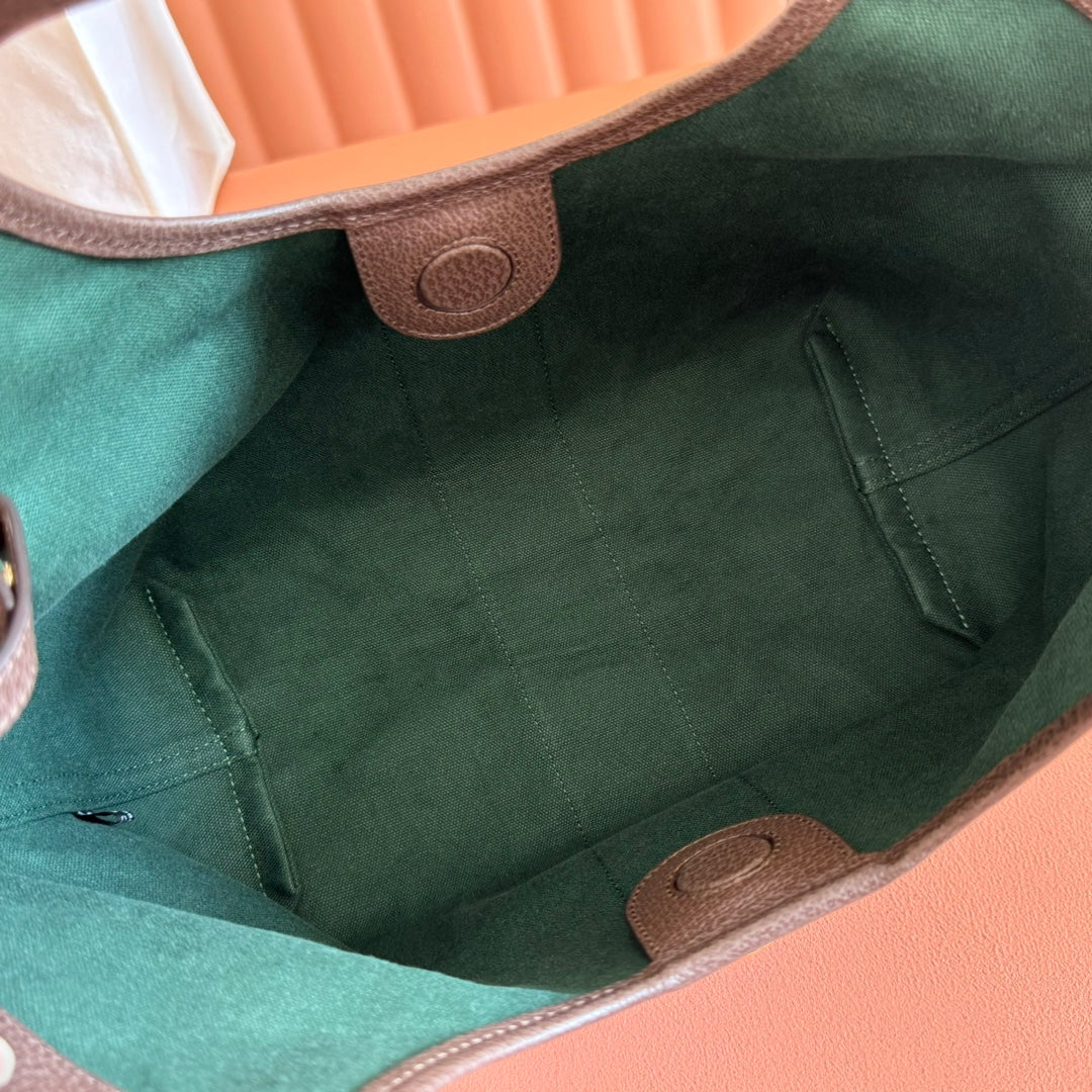 Gucci tote bag interior with green lining and brown leather snap tabs
