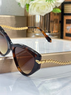 Bvlgari sunglasses side view with dark frames and braided gold temple detail