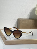 Bvlgari sunglasses with tortoiseshell frames, brown gradient lenses, braided gold temples