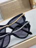 Bvlgari sunglasses close-up showing blue-black frames and metal braided temple detail