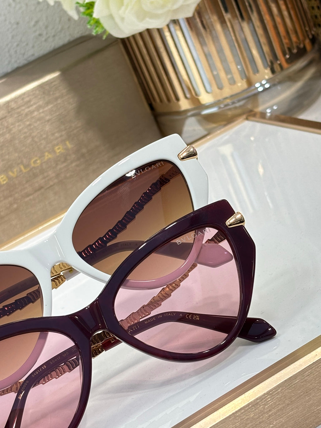 Bvlgari sunglasses close-up with white frame and burgundy lens accents