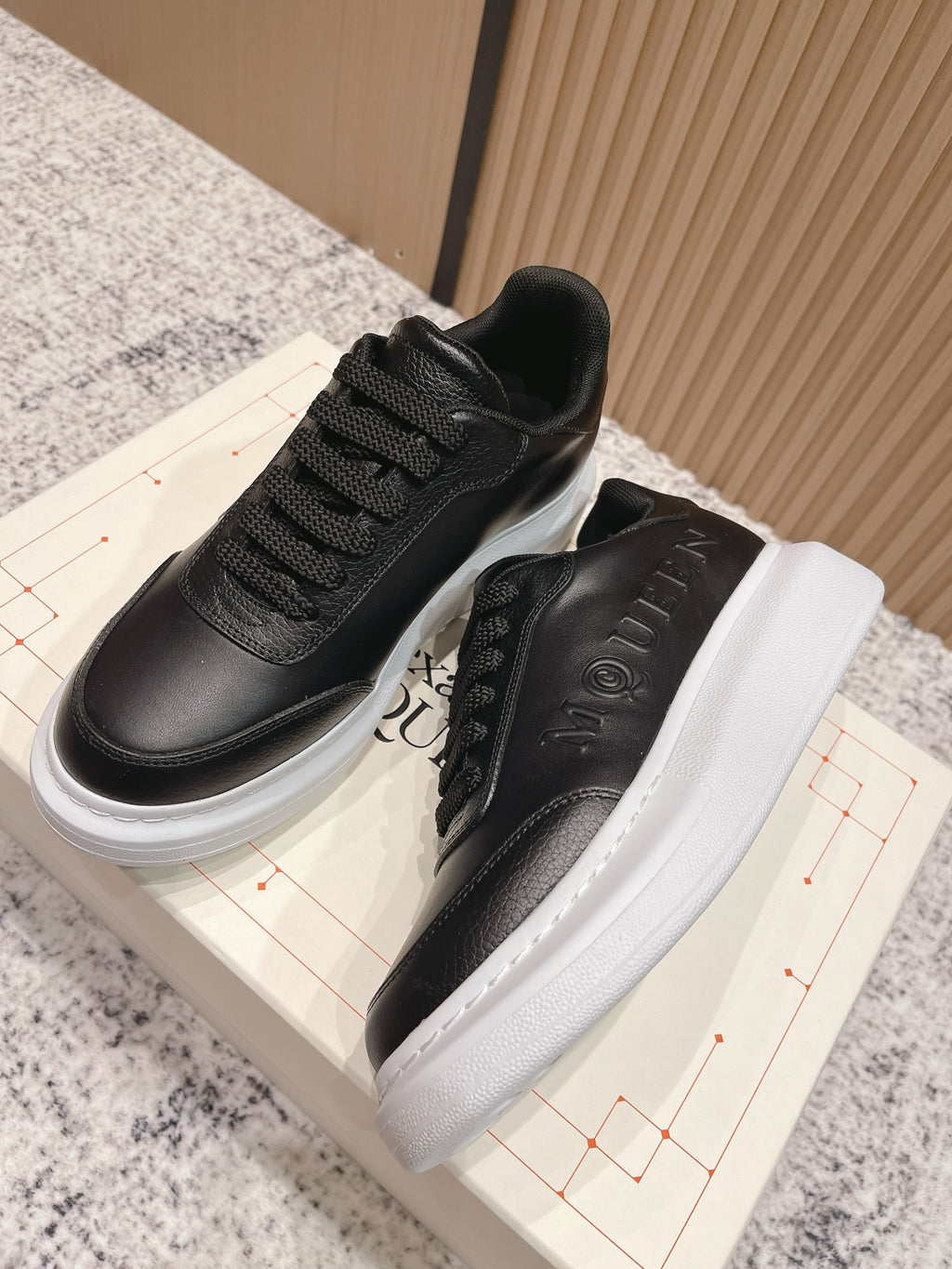 Alexander McQueen lace-up sneakers showing black tongue lining and white platform sole