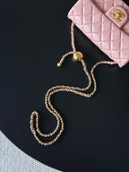 Chanel pink quilted bag with gold-tone chain strap and small charm details