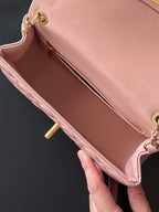 Chanel pink quilted bag interior with gold-tone zipper and chain