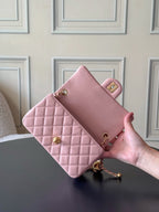Chanel pink quilted clutch with gold-tone clasp and chain strap