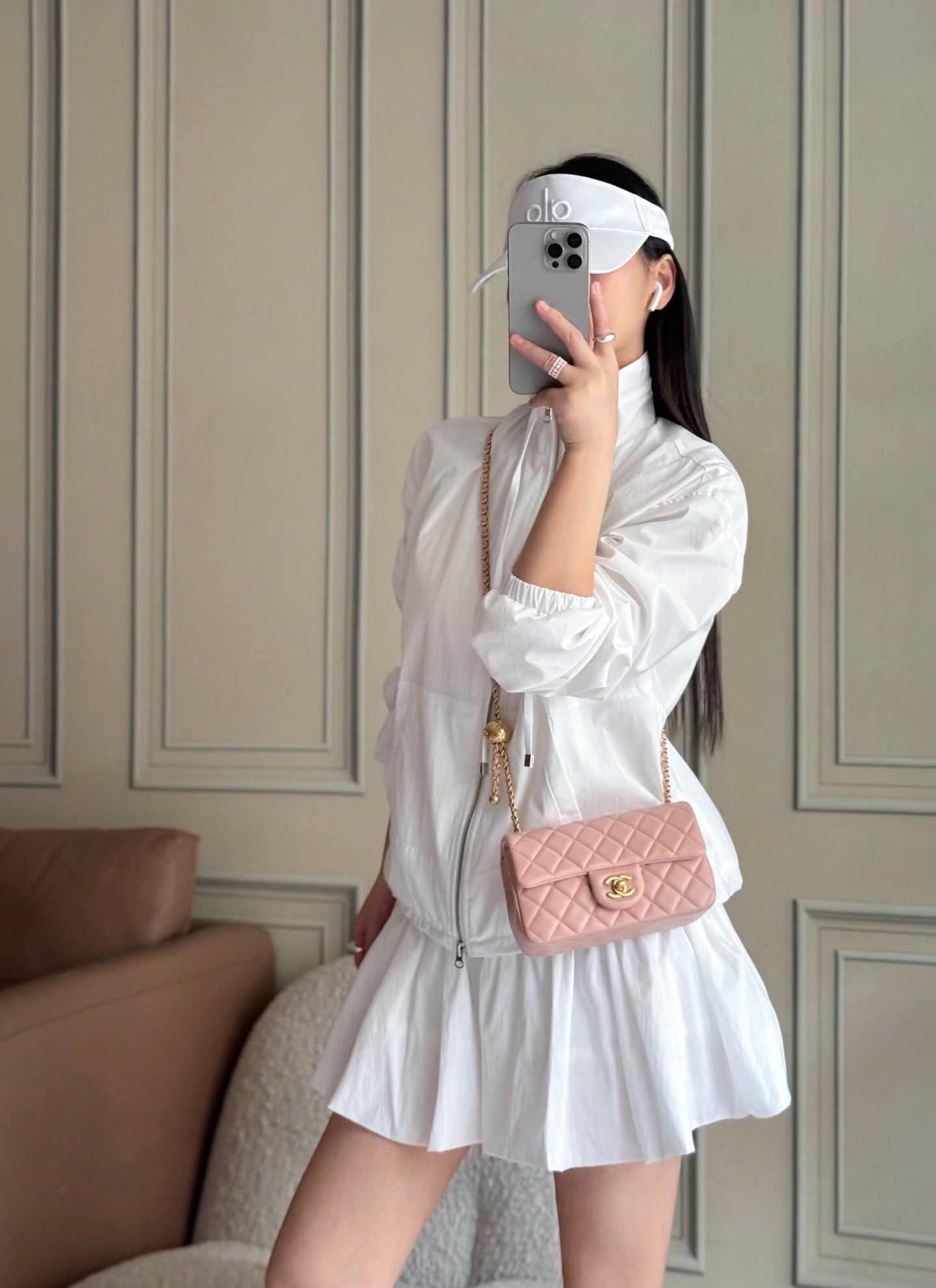 Chanel pink quilted mini shoulder bag worn with gold-tone chain strap