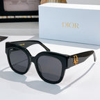 Black acetate sunglasses with rounded cat-eye frames and dark gray tinted lenses, Dior detail