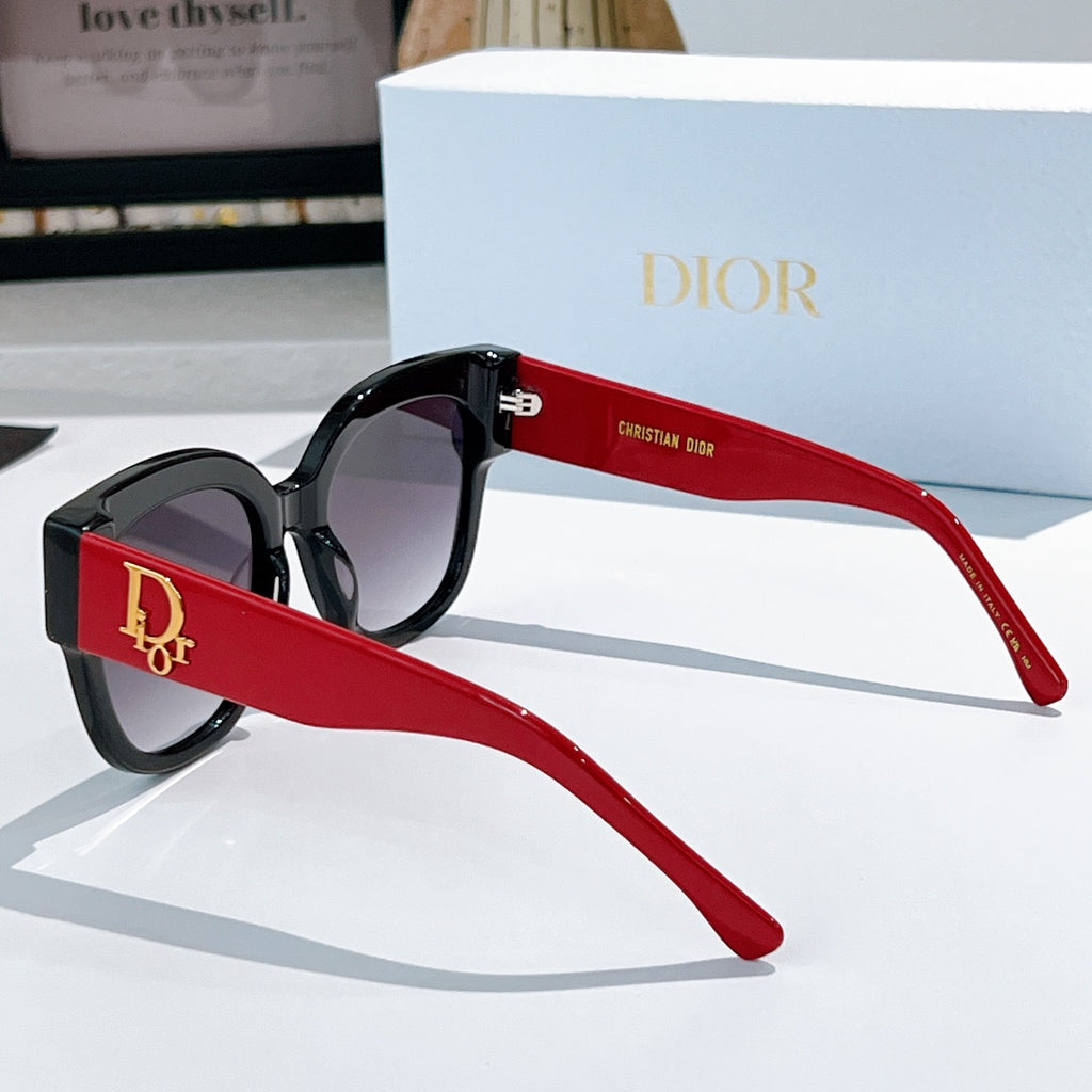 Black acetate sunglasses with rounded cat-eye frames and red temples, Dior detail