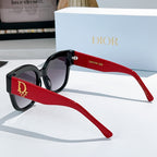 Black acetate sunglasses with rounded cat-eye frames and red temples, Dior detail
