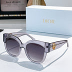 Silver acetate sunglasses with rounded cat-eye frames and dark gray tinted lenses, Dior detail