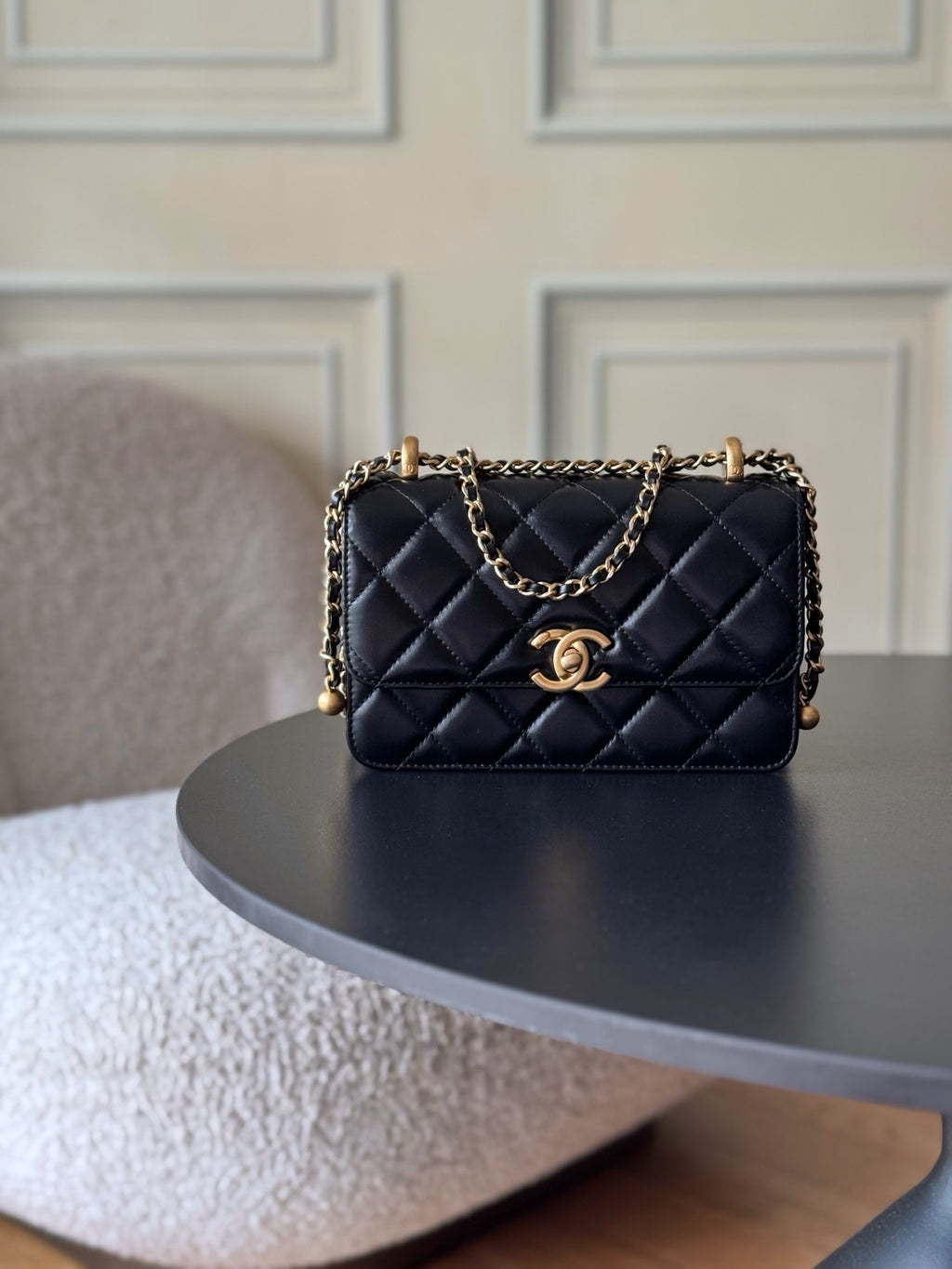 Quilted black flap shoulder bag with gold CC logo and chain strap