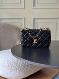 Quilted black flap shoulder bag with gold CC logo and chain strap