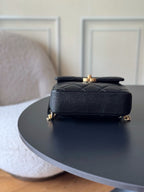 Chanel quilted leather mini bag, black with gold top hardware and chain strap